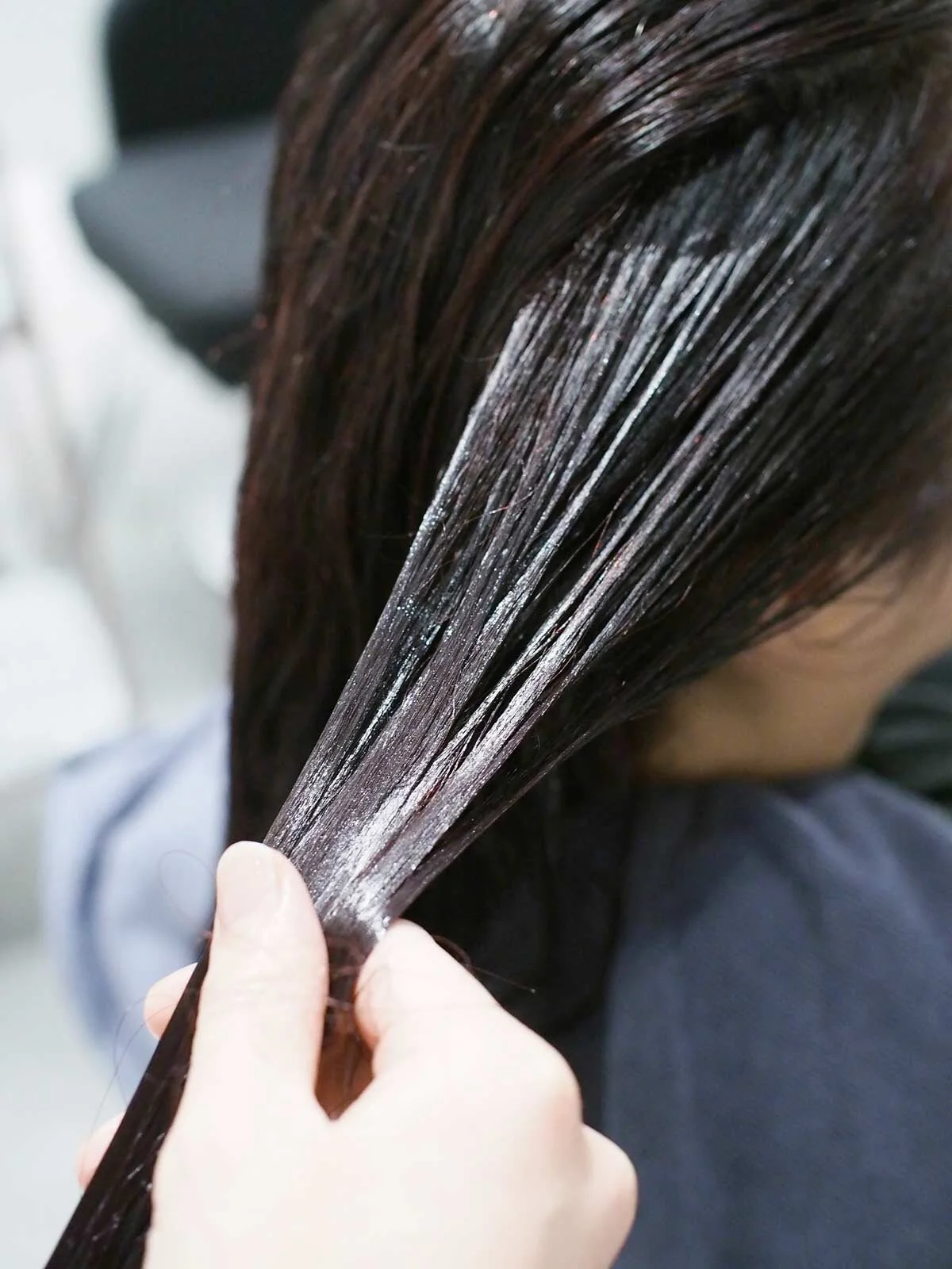 Meticulously massaging the sealer into the hair